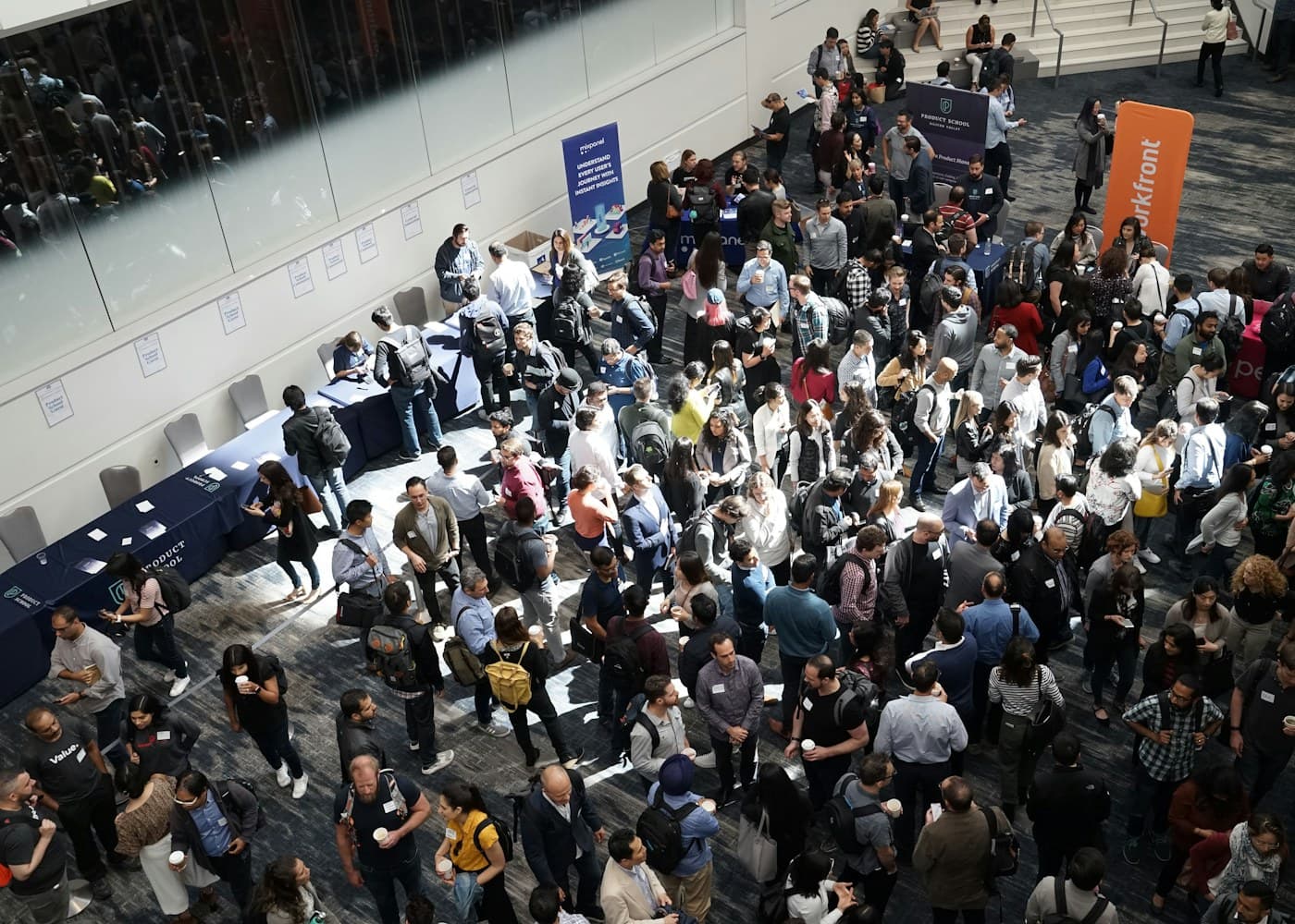 Exhibitor demonstrating equipment on a stand